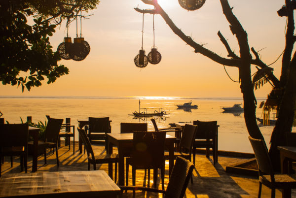 Beautiful beach with a cafe in Sanur with local traditional boats. Bali. Indonesia