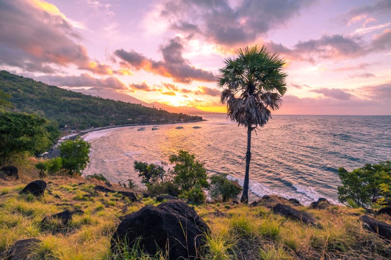 Stunning purple sunset overlooking Amed beach in Bali.