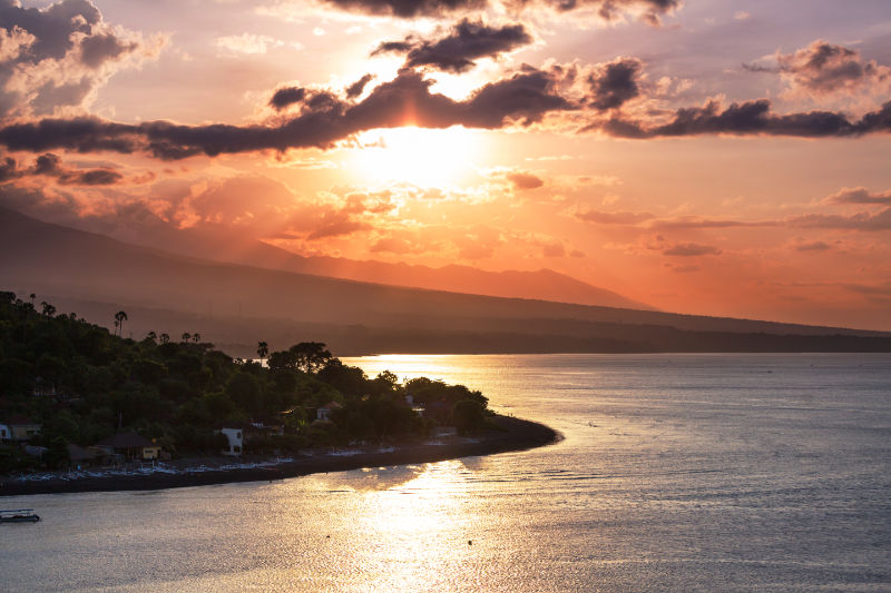 Sunset views of Jemaluk bay in Amed with Mt. Agung in the background.