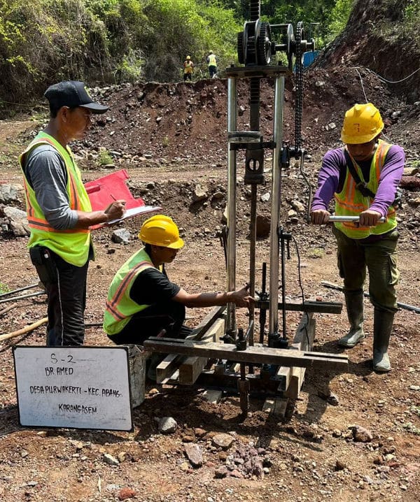 Drilling contractors on site testing for water supply.