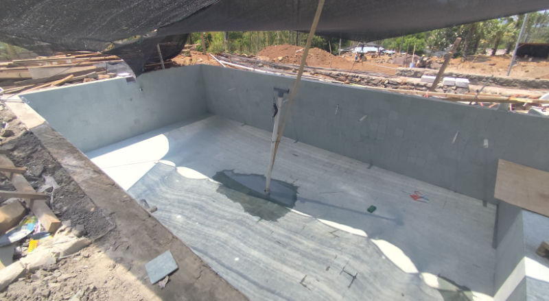 Swimming pool under construction with tiles