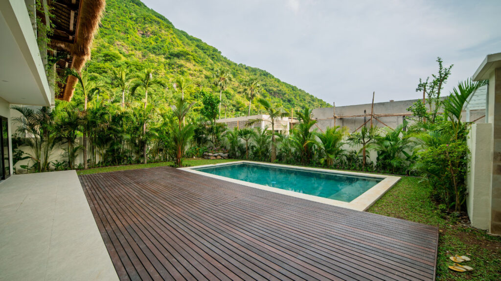 Landscaped garden and swimming pool at the Vesica Villas Celuke development in Amed, Bali.