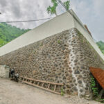 Riverstone boundary walls on villas being built in Amed