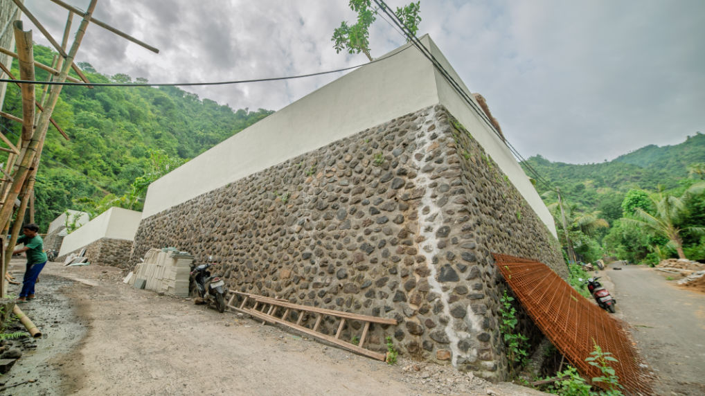 Riverstone boundary walls on villas being built in Amed