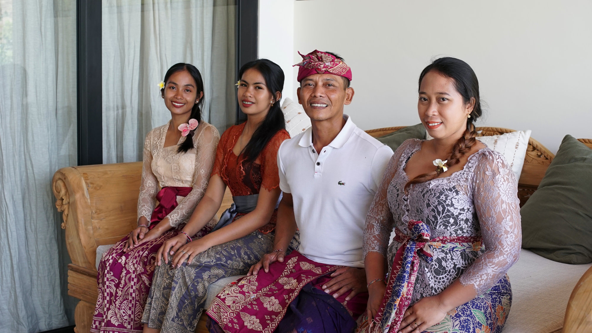 Balinese property services team sitting on a sofa in a luxury villa in Amed, Bali.